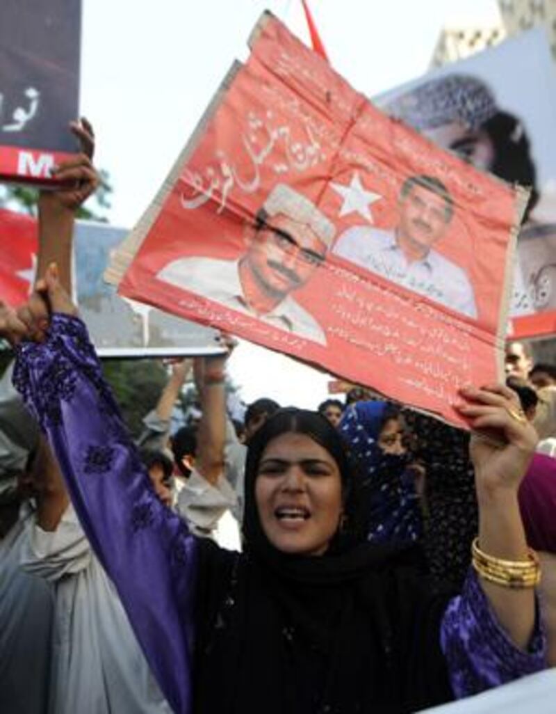Activists of the Baluch National Front carry placards picturing the murdered Baluch nationalist politicians during a protest in Karachi.