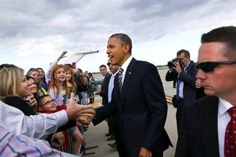 US President Barack Obama campaigns on Friday on his arrival at O'Hare International Airport in Chicago.