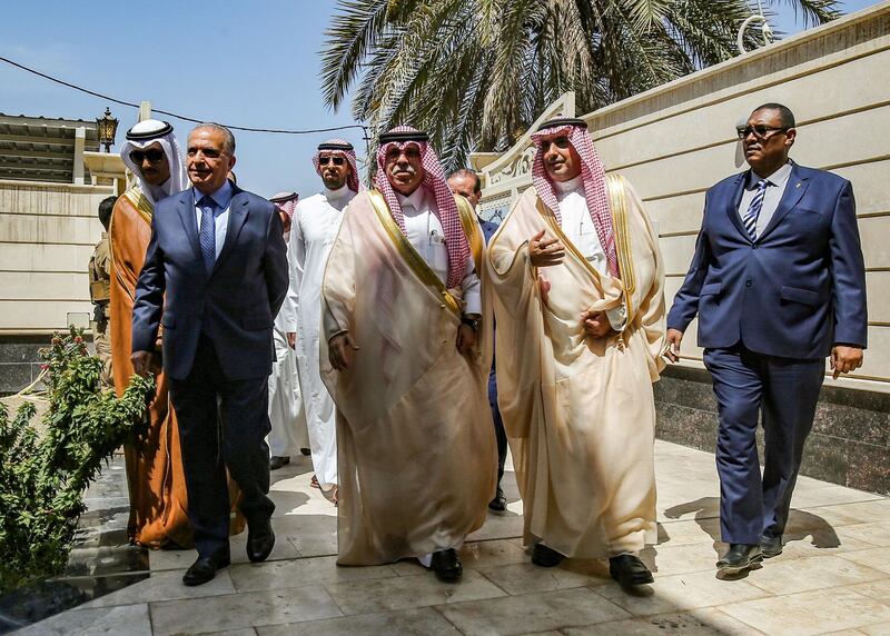 Iraqi Foreign Minister Mohammad Ali al-Hakim (L) arrives with Saudi Arabia's Trade and Investment Minister Majed al-Qasabi (C) during the inauguration of the new Saudi consulate compound in the high security "Green Zone" in the centre of the Iraqi capital Baghdad on April 4, 2019.  / AFP / AHMAD AL-RUBAYE
