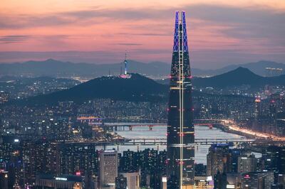 (FILES) A file photo taken on May 19, 2018 shows a general view of the Lotte tower (front C) and Namsan tower (rear C) amid the Seoul city skyline and Han river during sunset.  French "Spiderman" Alain Robert, who holds a world record for urban climbing, surrendered June 6, 2018 to a "cat and mouse" chase with security as he scaled a 123-story skyscraper in Seoul to celebrate the recent peace-making efforts between the two Koreas.
 - 
 / AFP / Ed JONES
