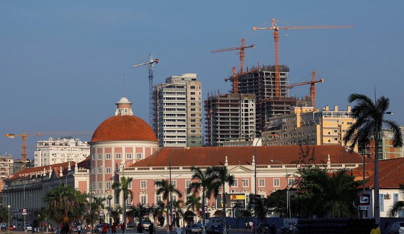 FILE PHOTO: Office blocks under construction stand behind the Angolan central bank building in the capital Luanda January 20, 2010. . REUTERS/Mike Hutchings/File Photo