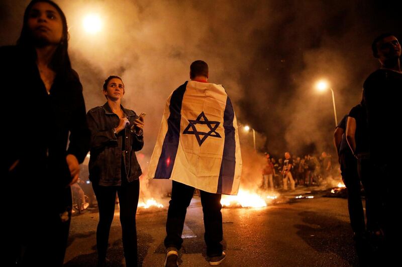 Residents of southern Israel protest against their government's decision to hold fire in Gaza in response to a similar decision by Palestinian militants, in Sderot, Israel November 13, 2018 REUTERS/ Amir Cohen