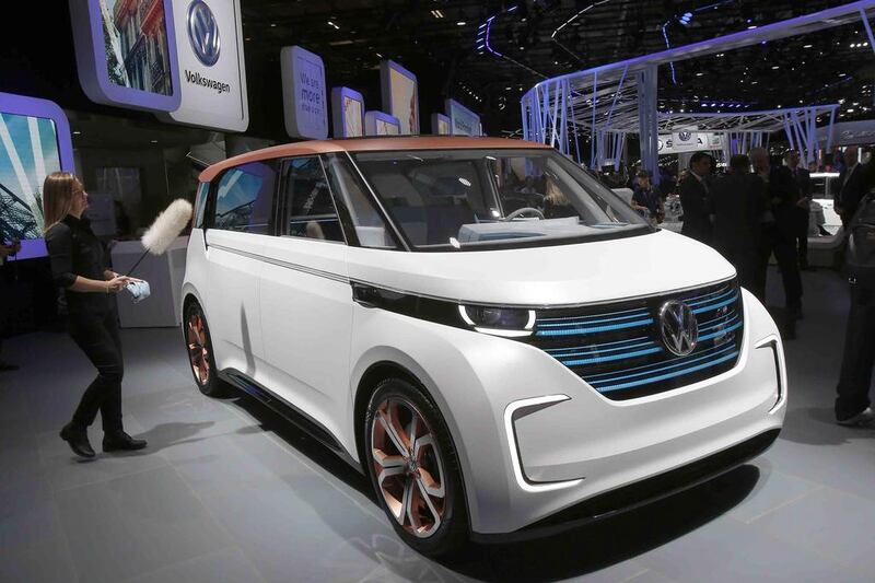 A worker polishes an electric concept car at the VW stand. Many major car makers are using the Paris show, held in a city whose mayor wants to ban diesels to reduce pollution, as the venue to show off new zero-emission electric cars. Michel Euler / AP