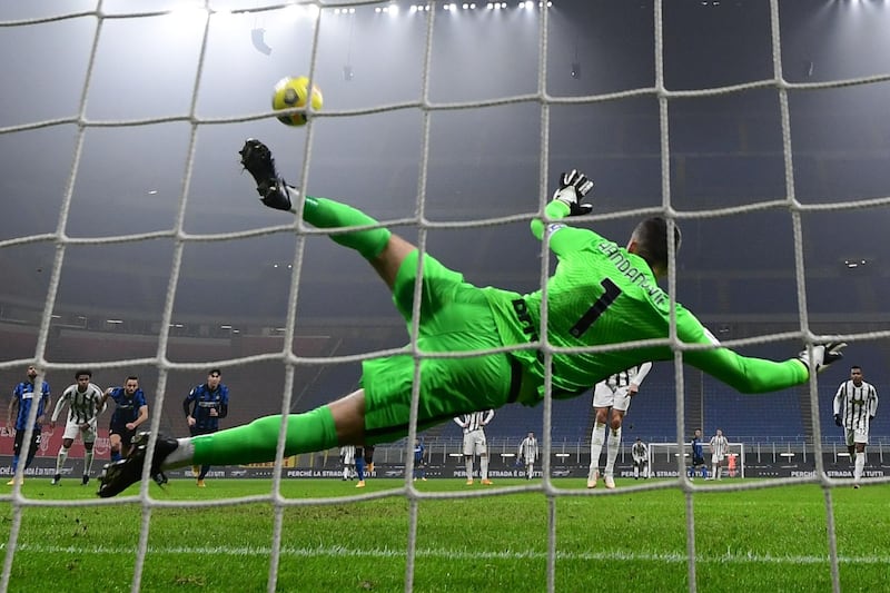 Inter Milan goalkeeper Samir Handanovic is beaten by a penalty from Juventus' Cristiano Ronaldo (partially hidden) during the Italian Cup quarter-final first-leg match at the San Siro on Tuesday, February 2. Juventus will take a 2-1 lead into the second leg. AFP