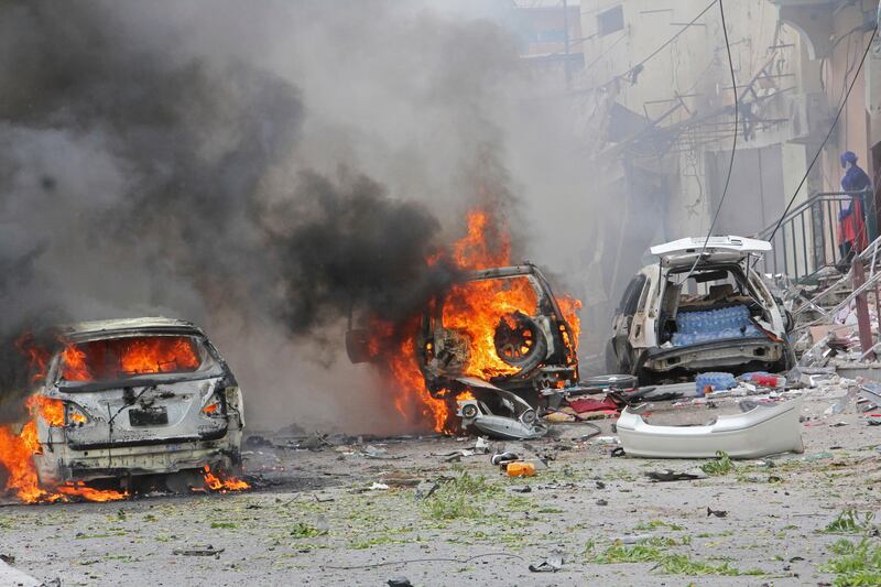 Burning vehicles outside Midnimo mall after a car bomb attack on a popular mall in Mogadishu, Somalia, Sunday, July 30, 2017. A police officer says a car bomb blast near a police station in Somalia's capital has killed at least five people and wounded at least 13 others. Most of the victims are civilians. The Somalia-based extremist group al-Shabab often carries out deadly bombings in Mogadishu. (AP Photo/Farah Abdi Warsameh)