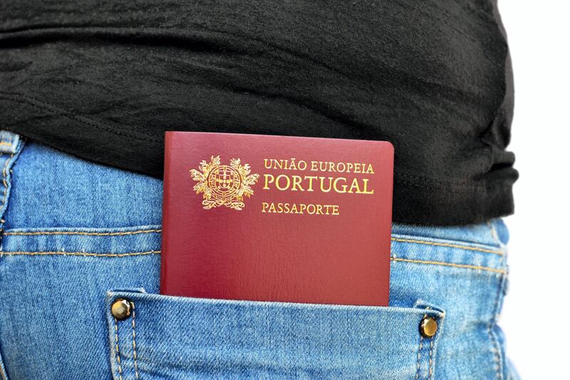 EM90GX Portuguese passport carried in a rear pocket of jeans pants