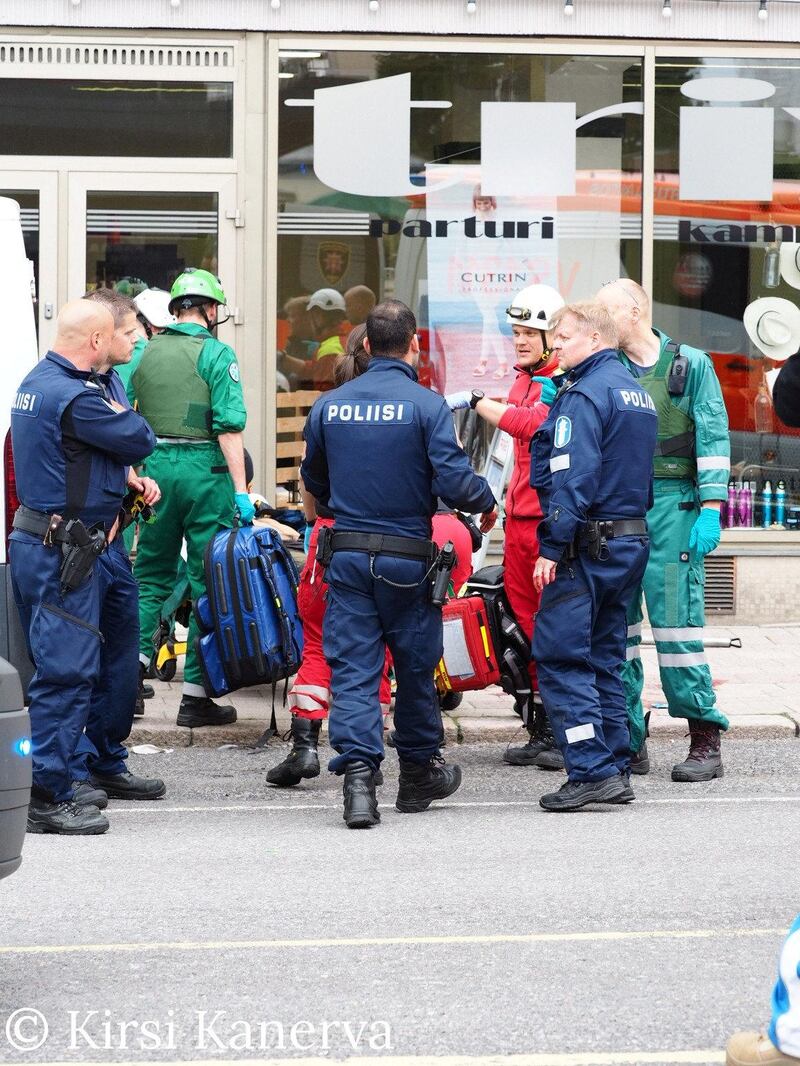 Police officers stand near the suspect after several people were stabbed, in Turku, Finland. Courtesy Kirsi Kanerva / Handout via Reuters.