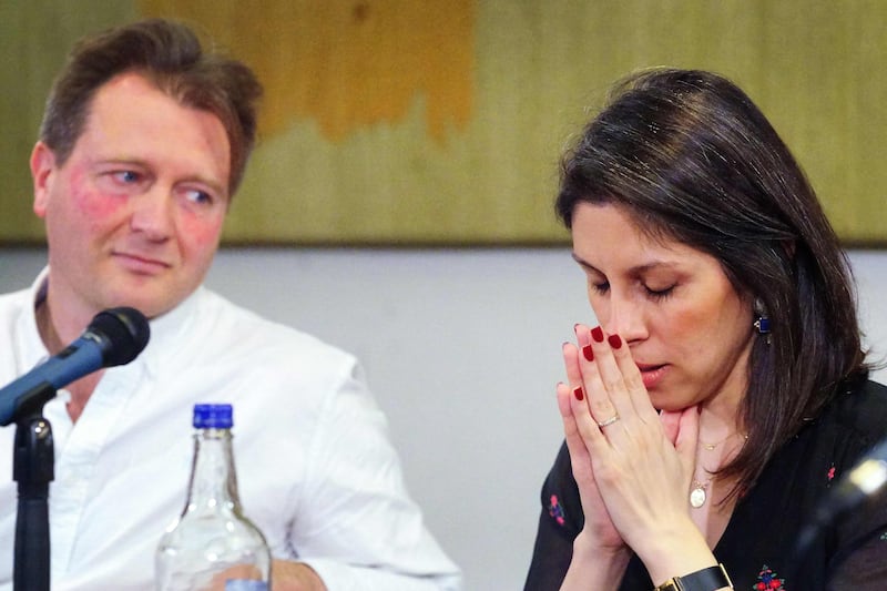 Mrs Zaghari-Ratcliffe, flanked by her husband, at the press conference. AFP