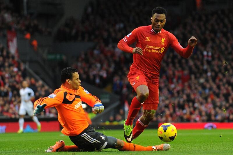 Liverpool's English striker Daniel Sturridge, right, rounds Swansea City's Dutch goalkeeper Michel Vorm to score the opening goal during the English Premier League football match between Liverpool and Swansea City at Anfield in Liverpool on February 23, 2014. Sturridge would add one more and Jordan Henderson would also score twice to lead Liverpool to a 4-3 win. Andrew Yates / AFP