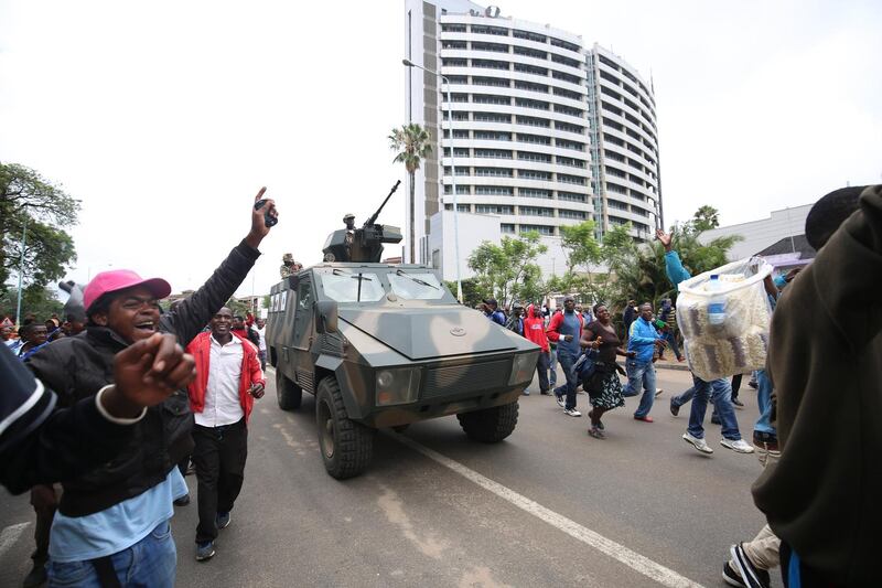 Protesters take part in a march along the city's streets, heading for a solidarity rally, on the removal of Zimbabwean president Robert Mugabe, at the Zimbabwe Grounds in Highfield, Harare. Aaron Ufumeli / EPA