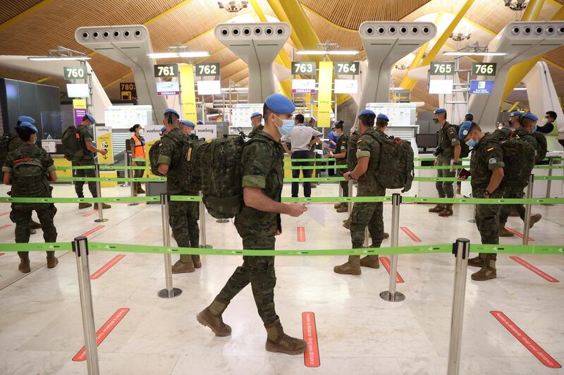 Spanish soldiers deployed to the United Nations Interim Force in Lebanon (UNIFIL) wear face masks as they prepare to travel to Lebanon following six months of training and two weeks of quarantine at the Adolfo Suarez Madrid-Barajas International Airport in Madrid, Spain.  EPA