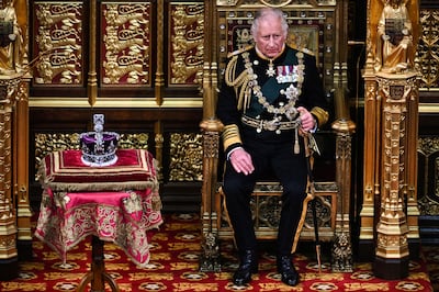 The then Prince Charles, Prince of Wales, now King Charles III, sits by the the Imperial State Crown in the House of Lords Chamber, during the State Opening of Parliament. AFP