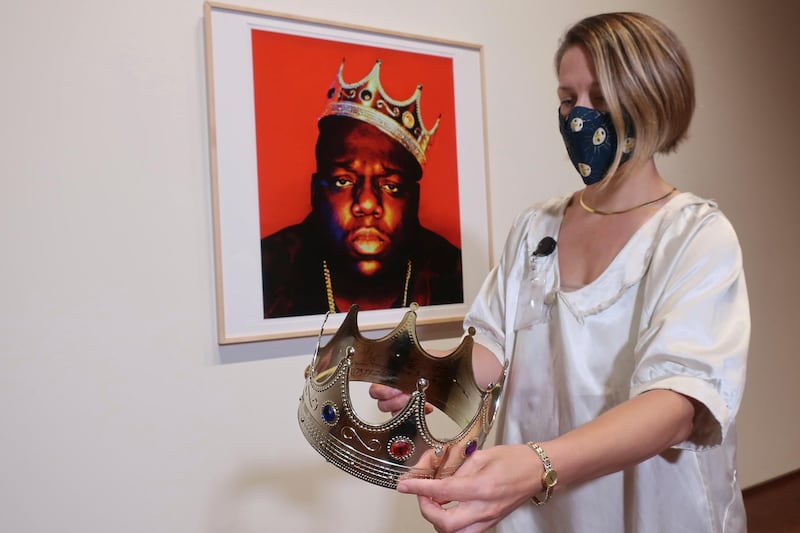 Sotheby's specialist Cassandra Hatton holds the plastic crown worn and signed by the Notorious BIG. Photographer Barron Claiborne provided the crown prop to portray Biggie Smalls as the king of New York during a 1997 photo shoot for the cover of 'Rap Pages' magazine, held three days before the rapper was killed. AP photo
