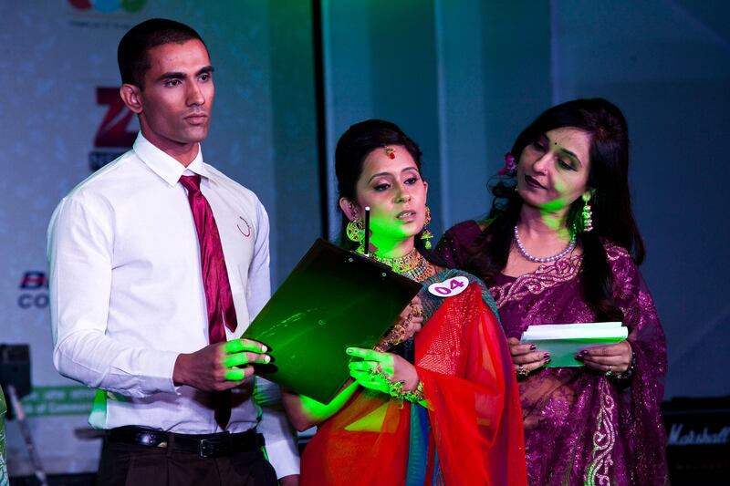 2nd runner-up Seema Sharma (#4, red/blue), aged 34, during the question and answer test at the final round of the inaugural AAS Housewives Awards 2012 on 19th May 2012 in New Delhi, India. Out of 12 selected semi-finalists, 6 finalists are chosen based on a question and answer session on stage, and other criteria such as poise. The winner, and 1st and 2nd runner-ups are Jyoti Nagpal (#2), Nisha Sharma (#7) and Seema Sharma (#4)respectively. The awards also served as a platform for Cervical Cancer Awareness. Photo by Suzanne Lee for The National