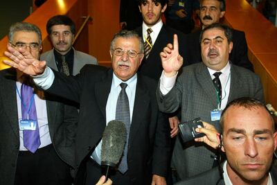 Kurdish rebel leader Jalal Talabani, centre, and his delegation arrive for a meeting of Iraqi opposition groups in London in December 2002. AFP
