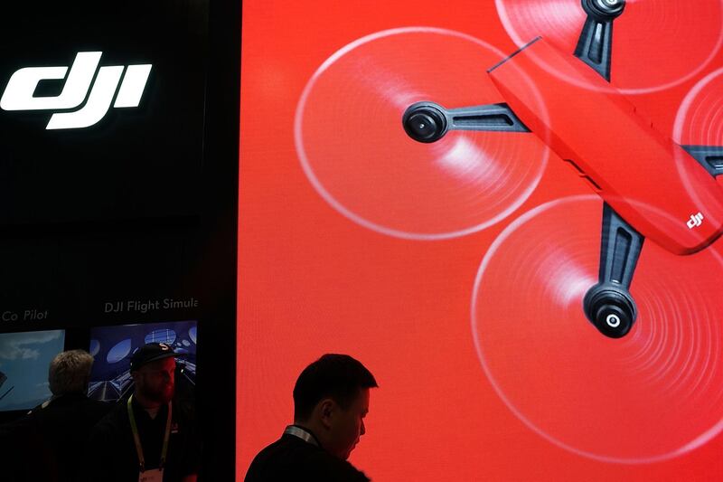 LAS VEGAS, NV - JANUARY 11:  An employee stands in front of a screen at the DJI booth during CES 2018 at the Las Vegas Convention Center on January 11, 2018 in Las Vegas, Nevada. CES, the world's largest annual consumer technology trade show, runs through January 12 and features about 3,900 exhibitors showing off their latest products and services to more than 170,000 attendees.  (Photo by Alex Wong/Getty Images)