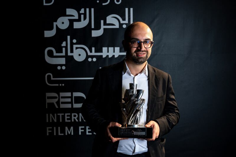 Haider Rashid poses with his Best Director award for his film 'Europa'. Photo: Red Sea International Film Festival / AFP