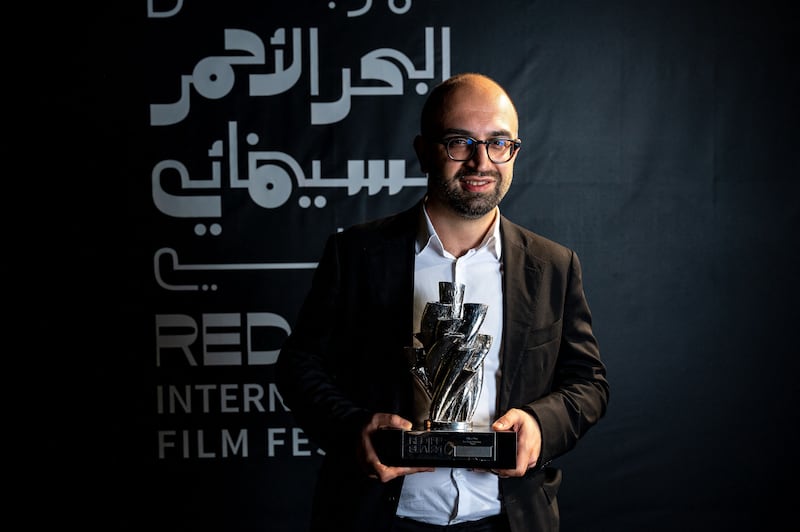 Haider Rashid poses with his Best Director award for his film 'Europa'. Photo: Red Sea International Film Festival / AFP