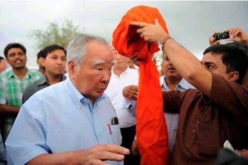 Japanese chairman and chief executive of Suzuki Motor Corporation, Osamu Suzuki, is given a traditional turban during a visit to Hansalpur village, around 110 kms from Ahmedabad. The company may review its strategy following deadly unrest  at its factory in  Manesar, Haryana.