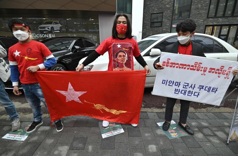 Protesters hold a flag of Aung San Suu Kyi's National League for Democracy party during an anti-coup demonstration near the military office of the Myanmar embassy in Seoul.  AFP