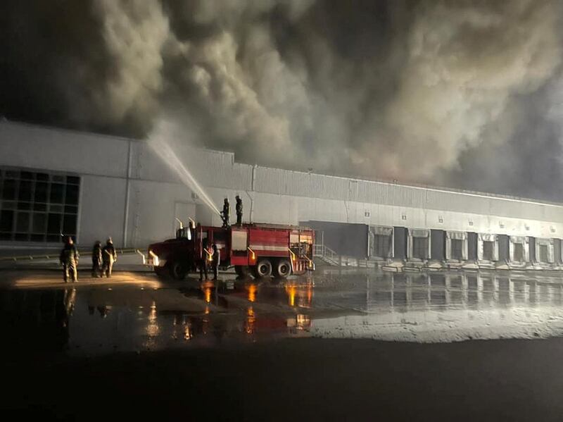 Firefighters battle a blaze at a warehouse storing frozen products hit by shelling in Kvitneve, Kyiv region. Reuters