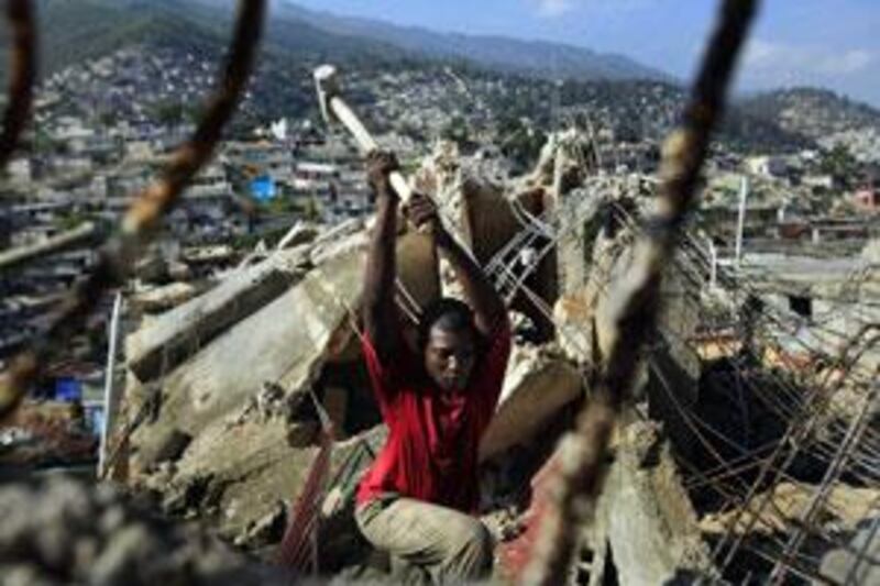 A public employee works on the demolition of a collapsed building in the Pacot neighbourhood of Port-au-Prince.