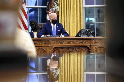 U.S. President Joe Biden signs executive orders on immigration reform inside the Oval Office at the White House in Washington, U.S., February 2, 2021. REUTERS/Tom Brenner