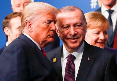 (FILES) In this file photo taken on December 4, 2019, US President Donald Trump (L) and Turkey's President Recep Tayyip Erdogan (R) leave the stage after the family photo to head to the plenary session at the NATO summit at the Grove hotel in Watford, northeast of London. President Donald Trump has shattered through norms and niceties on the world stage in his nearly three years in office. Entering an election year, Trump is unlikely to slow down as he seeks what has largely eluded him -- a headline-grabbing victory. The tycoon turned president closes 2019 with a new stride after what was perhaps his most unambiguous achievement -- US commandos' raid that killed the leader of the Islamic State extremist group. But the year was also full of tosses and turns for Trump. On his ambition to end the war in Afghanistan, he startled Washington by inviting the Taliban to talks but then declared the talks dead before resuming them. / AFP / POOL / PETER NICHOLLS / TO GO WITH AFP STORY by Shaun TANDON, "Trump on quest for foreign wins -- and drama -- in election year"
