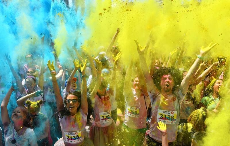 People take part in the Kyiv Color Run in Kiev on June 10, 2018. 
 From the first event in the United States in January 2012 The Color Run has since spread across the globe leaving a trail of color and happy runners. / AFP / Sergei SUPINSKY

