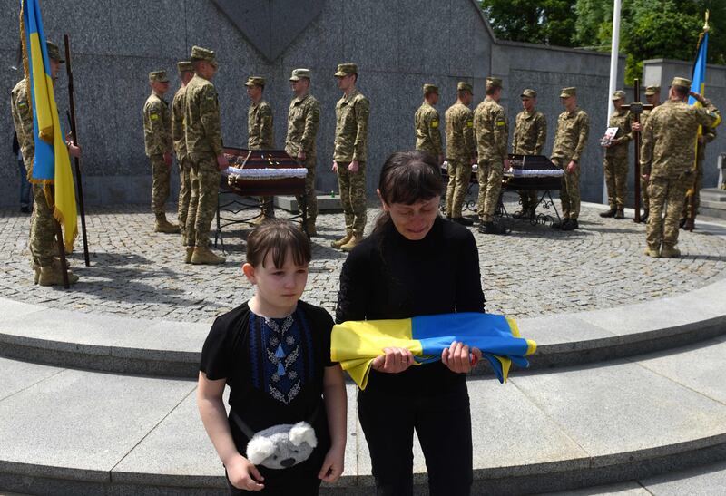 Widow and daughter of Andriy Vertiev, a Ukrainian serviceman, killed during the Russian invasion of Ukraine, attend his funeral at Lychakiv cemetery, Lviv, Ukraine. AFP