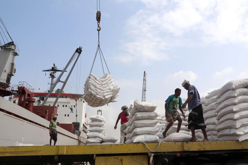 Workers unload wheat assistance provided by UNICEF from a cargo ship at the Red Sea port of Hodeida on January 27, 2018.
Hodeida is a key entry point for United Nations aid to war-torn Yemen. / AFP PHOTO / ABDO HYDER