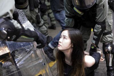 A young female demonstrator is arrested by police during clashes in the Causeway Bay area of Hong Kong. Rick Findler for The National