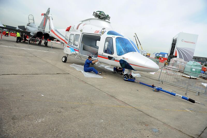 Employees assemble an AgustaWestland helicopter, owned by Italy's Finmeccanica, at the Paris International Air Show -- June 14, 2013 -- . (Antoine Antoine for The National) *** Local Caption ***  Paris Air Show018.JPG