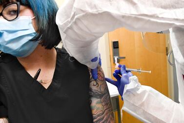 Nurse Kathe Olmstead injects volunteer Melissa Harting with a possible Covid-19 vaccine, developed by the National Institutes of Health and Moderna Inc., in Binghamton, NY, July 27. AP