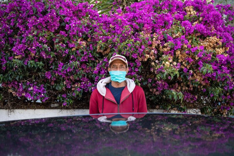 Ibrahim, a parking attendant, poses for a photo in his face mask during the coronavirus pandemic in Rabat, Morocco.  AP