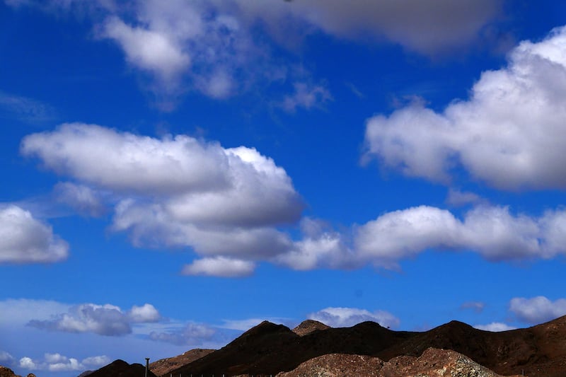 Clouds darken the mountain peaks in the Northern Emirates. 