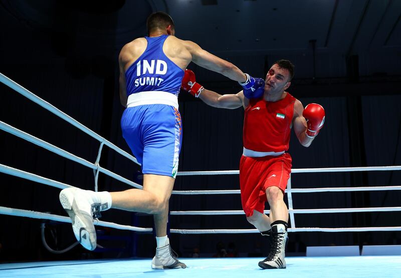 Meysam Gheshlaghi of Iran (red) is caught by a punch from Sumit Sangwan of India (blue) in the men's light heavyweight 81kg preliminary bout at the Asian Boxing Championships. Getty Images