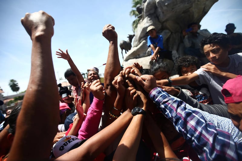 Central American migrants, moving in a caravan through Mexico, join their hands during a demonstration against the U.S President Donald Trump's immigration policies, in Hermosillo, Senora state, Mexico April 23, 2018. REUTERS/Edgard Garrido