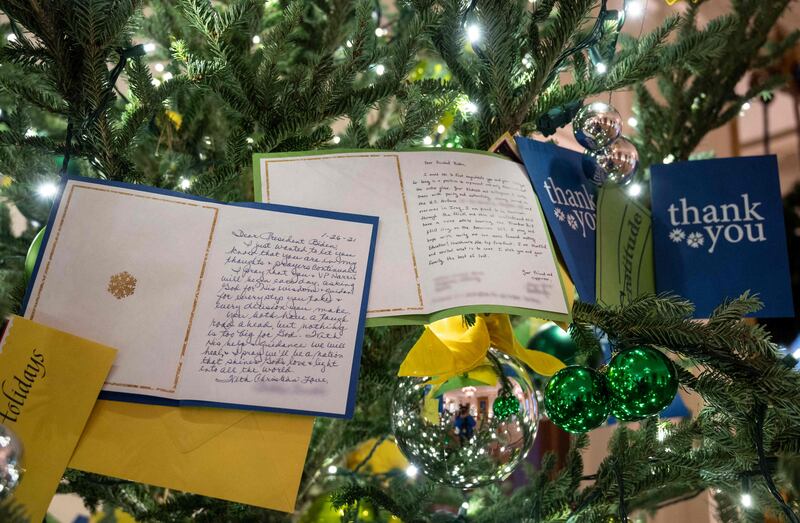 Letters to US President Joe Biden decorate a Christmas tree in the East room. AFP