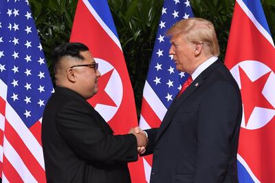 North Korea's leader Kim Jong Un (L) shakes hands with US President Donald Trump (R) at the start of their historic US-North Korea summit, at the Capella Hotel on Sentosa island in Singapore on June 12, 2018. Donald Trump and Kim Jong Un have become on June 12 the first sitting US and North Korean leaders to meet, shake hands and negotiate to end a decades-old nuclear stand-off. / AFP / SAUL LOEB
