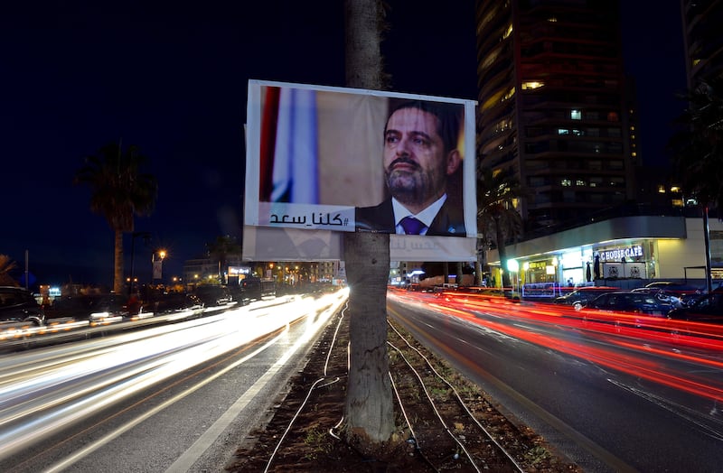 epa06320674 A photograph taken with low shutter speed shows a poster of Prime Minister Saad Hariri and Arabic words reading 'We are all Saad' hanging on a street in Beirut, Lebanon, 10 November 2017. Lebanese Prime Minister Saad Hariri Announced on 04 November 2017 that he resigns from the Prime Minister's office. According to media reports, Hariri said that the current political climate reminds him with the time before the assassination of his father, former Lebanese Prime Minister Rafic Hariri, and he also mentioned Iran's influence in his country, and the region. Hariri came into office for his second term on 18 December 2017.  EPA/WAEL HAMZEH