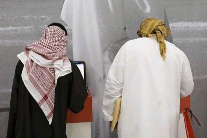 Emiratis attend the Abu Dhabi Recruitment Show at the Abu Dhabi Exhibition Center. Lauren Lancaster / The National
