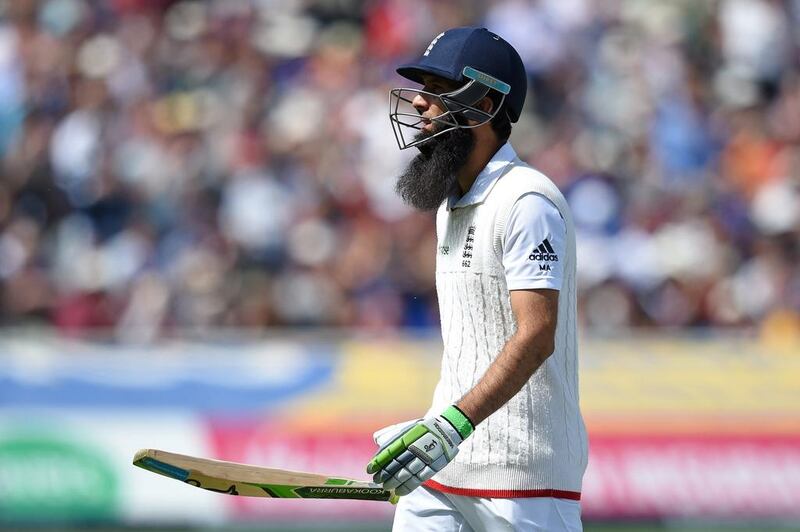 Moeen Ali walks back to the pavilion after being caught out for 59 runs. Paul Ellis / AFP