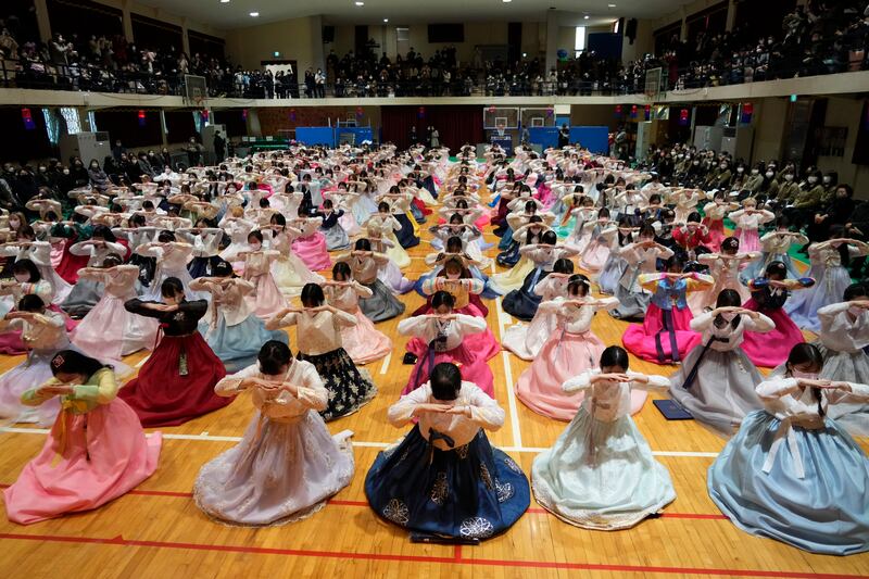 Senior pupils clad in traditional attire bow during a joint graduation and coming-of-age ceremony at the Dongmyung Girls' High School, in Seoul, South Korea. AP