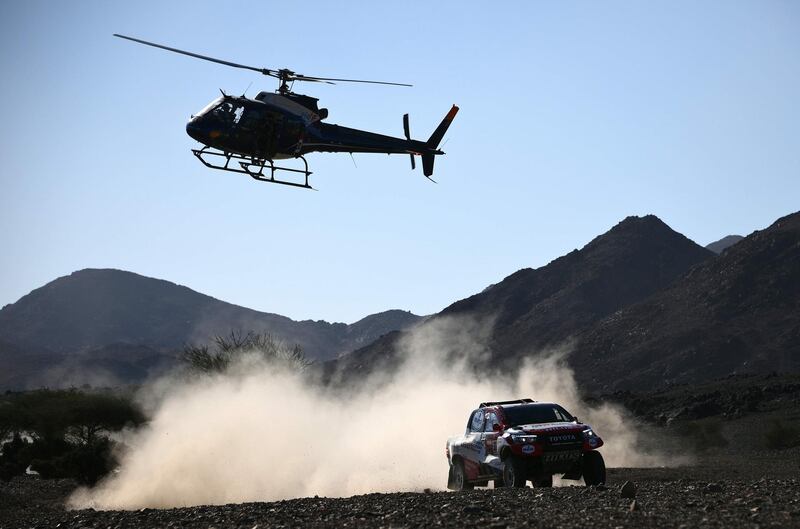 A helicopter flies overhead as Fernando Alonso and co-driver Marc Coma compete during Stage 2 of the Dakar Rally in Saudi Arabia. AFP