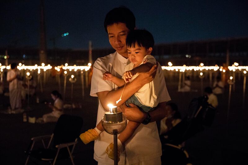 Devotees light candles at the temple. Getty