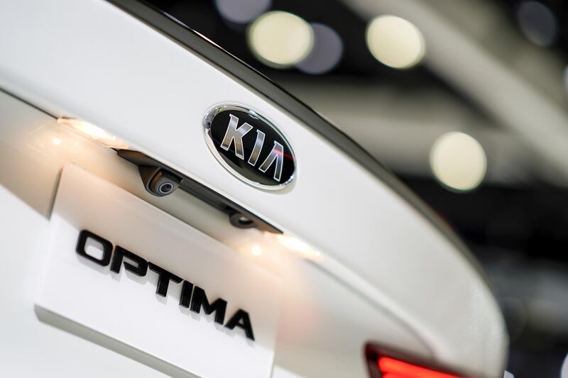 A Kia Motors Corp. badge is displayed on the back of a 2020 Kia Optima hybrid vehicle at the AutoMobility LA ahead of the Los Angeles Auto Show in Los Angeles, California, U.S., on Thursday, Nov. 21, 2019. Engines are taking a back seat to motors at this years Los Angeles Auto Show as carmakers showcase the latest electric additions to their vehicle lineups. Photographer: Kyle Grillot/Bloomberg
