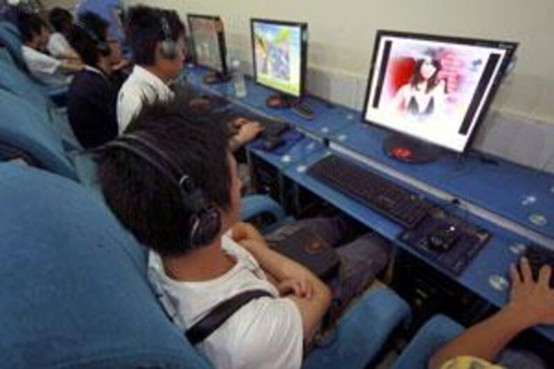 Customers use computers at an internet cafe in Suining, Sichuan province, on June 10 2009.