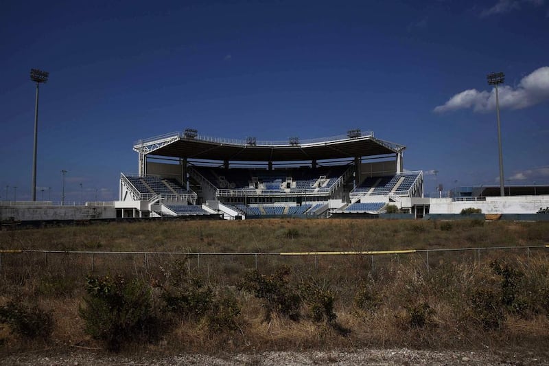 The abandoned stadium that hosted the softball competition during the 2004 Athens Olympic Games is seen at the Hellenikon complex, south of Athens, on July 16, 2014. Ten years after Greece hosted the world's greatest sporting extravaganza, many of its once-gleaming Olympic venues have been abandoned while others are used occasionally for non-sporting events such as conferences and weddings. For many Greeks who swelled with pride at the time, the Olympics are now a source of anger as the country struggles through a six-year depression, record unemployment, homelessness and poverty. Just days before the anniversary of the Aug. 13-29 Games in 2004, many question how Greece, among the smallest countries to ever host the Games, has benefited from the multi-billion dollar event. Yorgos Karahalis / Reuters
