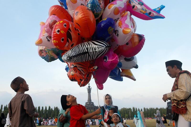 Muslim children play with balloons during Eid al-Fitr celebration at Puputan field in Denpasar, Bali, Indonesia. Reuters